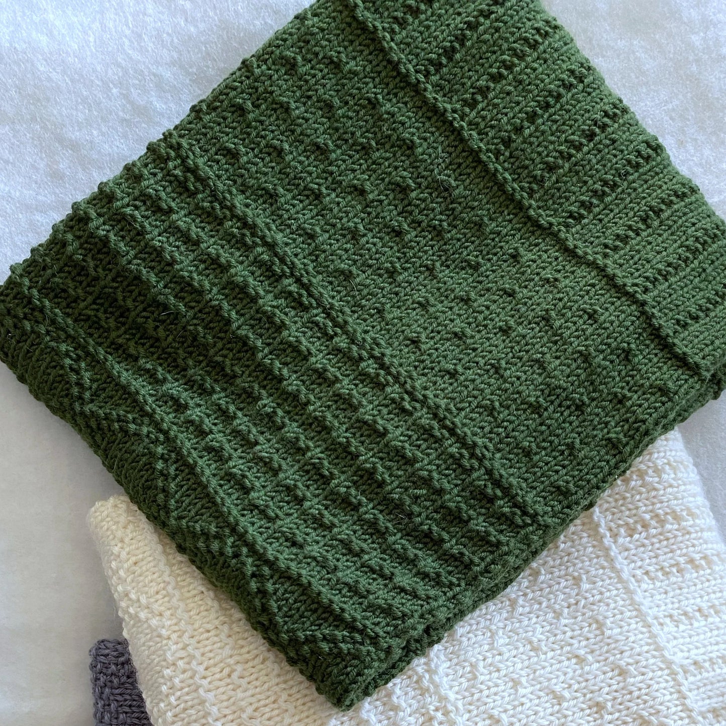 "Daisy" hand knit merino baby cot blanket