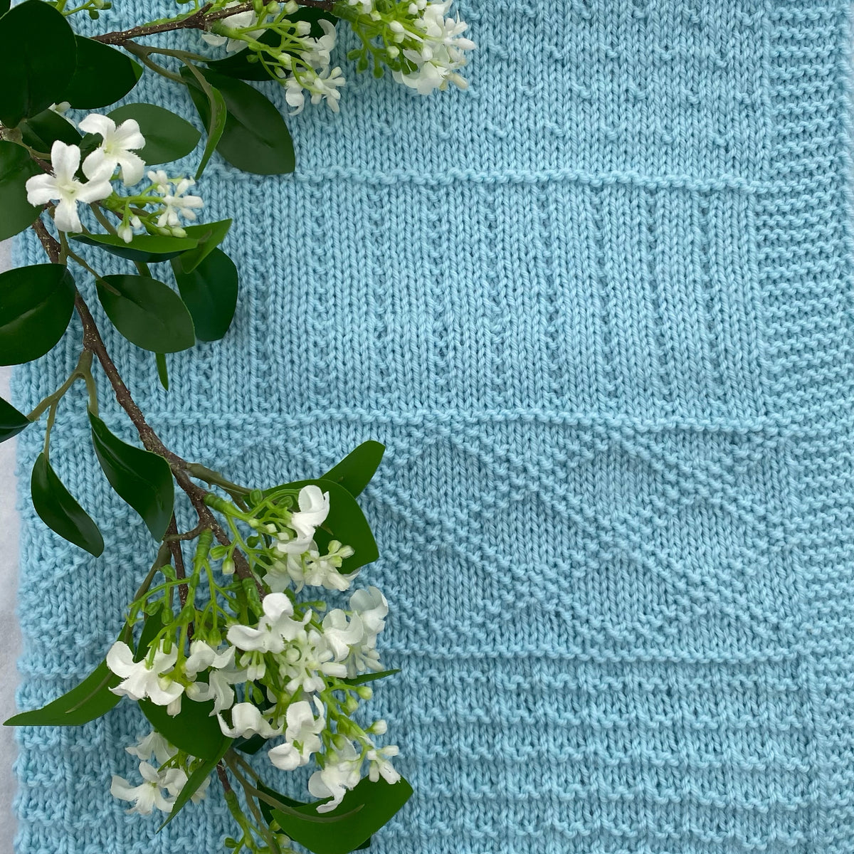 "Daisy" hand knit merino baby cot blanket